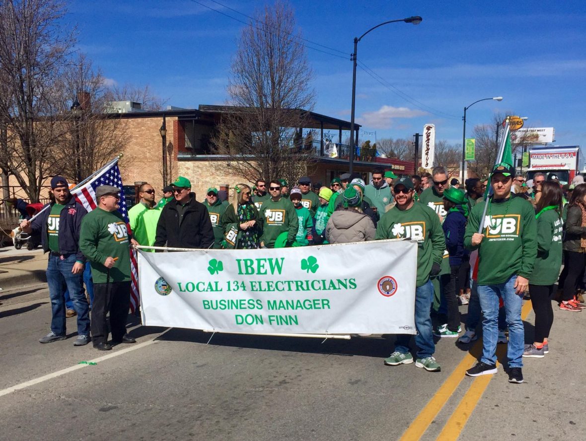 Members of IBEW Local 134 march in the St. Patrick's Day parade.